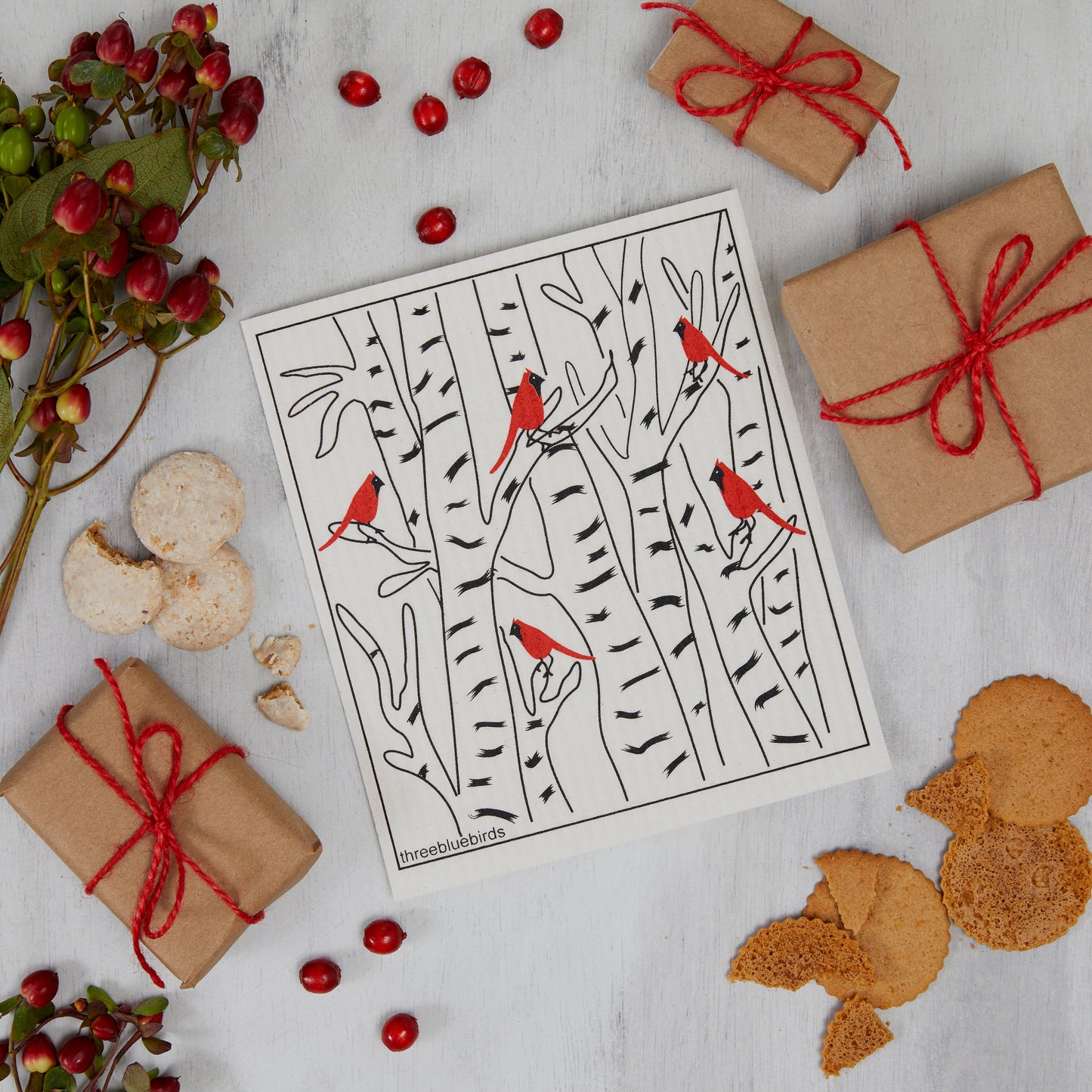 Winter Cardinals Three Bluebirds Swedish Dishcloth amongst berries and presents.